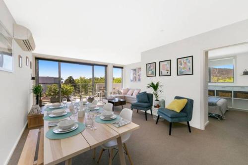 a large living room with a table and chairs at 3BR Braddon Flat, 8 mins walk to CBD - Hosted by Canstay in Canberra