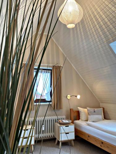 a attic bedroom with a bed and a window at Ferienwohnung Annika 2 in Tinnum