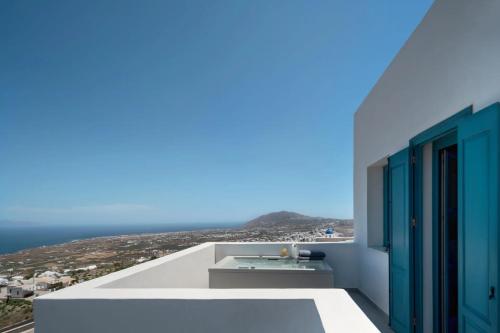 a view of the ocean from the balcony of a house at Aeifos Boutique Hotel in Imerovigli