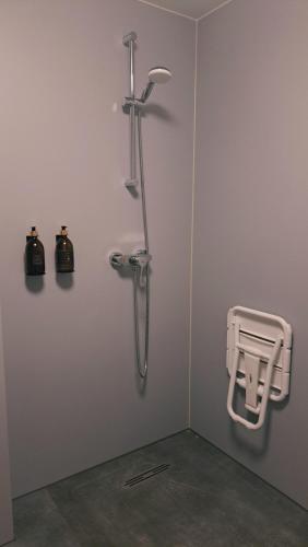 a shower in a room with a wall with a shower at Stadsklooster Dordt Hotel&Hostel in Dordrecht