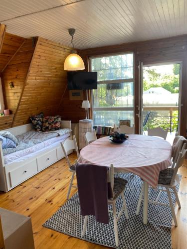 a living room with a table and a couch at Romantyczny zakątek w Wińcu in Winiec
