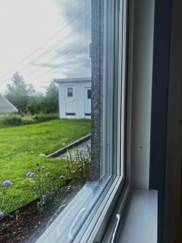 a window with a view of a yard at Apartment in Lillestrøm with free parking and great view, sleep 3 people in Lillestrøm