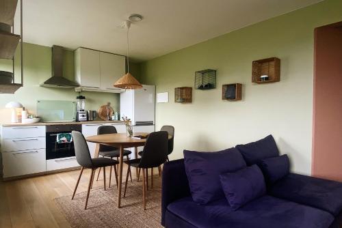 a living room with a blue couch and a table at Apartment in Lillestrøm with free parking and great view, sleep 3 people in Lillestrøm