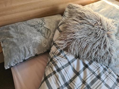 a bed with a pillow with a deer on it at The Mayflower in Millom