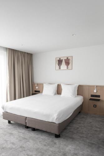 Letto o letti in una camera di Hotel Le Bois De Bruges