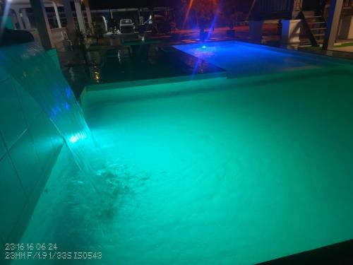 a swimming pool with blue lights in the water at Tein room in Rengit