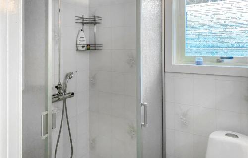 a bathroom with a shower with a glass door at 1 Bedroom Awesome Home In Gränna in Gränna