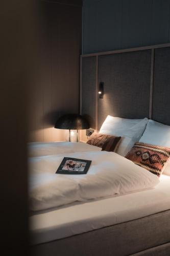 a bedroom with a bed with a picture on it at Henningsvær Bryggehotell - by Classic Norway Hotels in Henningsvær