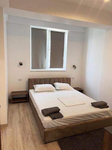 a bedroom with a bed with two towels on it at Rion Apartment in Saturn