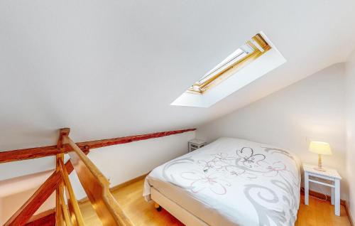 a small attic bedroom with a bed and a skylight at Beautiful Home In Taintrux With Wifi in Taintrux