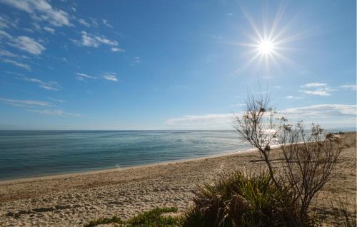 a sandy beach with the sun in the sky at Gorgeous Home In Prunelli Di Fiumorbo in Prunelli-di-Fiumorbo
