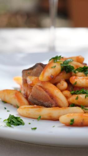 a plate of food with meat and french fries at Agriturismo il Vignaletto in Martina Franca