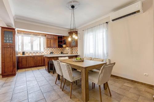 a kitchen with a dining room table and chairs at Casa NB in Gouvia