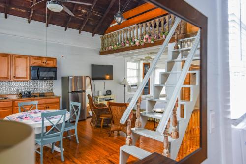 a white spiral staircase in a kitchen with a table at New Rose Retreat - Pool & Parking in Key West