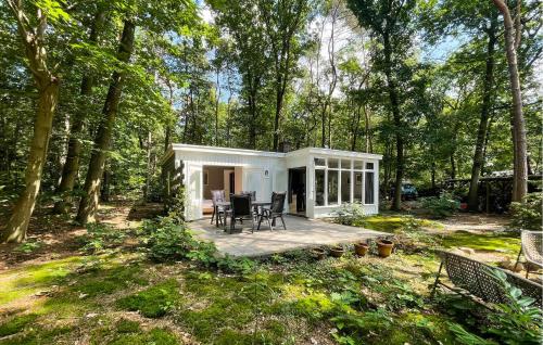 a tiny house in the woods with a deck at 3 Bedroom Lovely Home In Holten in Holten