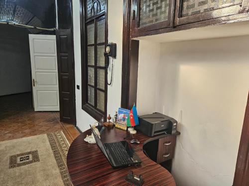 a desk with a laptop and a printer on it at Freestyle Hostel Baku in Baku