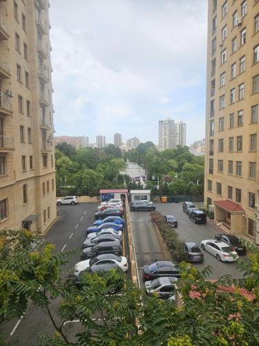 a parking lot with parked cars in a city at Freestyle Hostel Baku in Baku