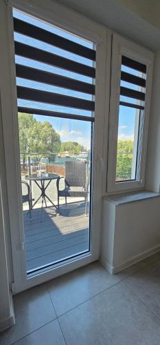 a room with a window with a view of a patio at Biały Port in Rajgród