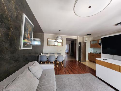 a living room with a couch and a table at Apartament Karkonoska z garażem in Wrocław