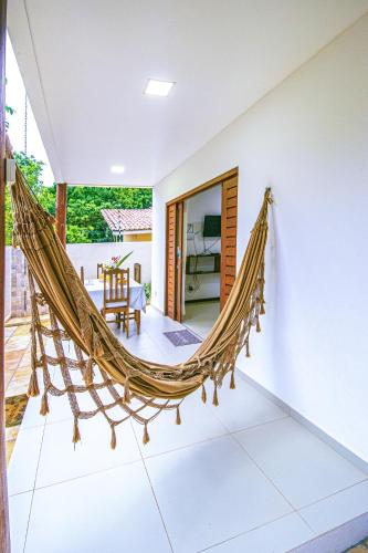 a hammock in the living room of a villa at Lovely Pipa in Pipa