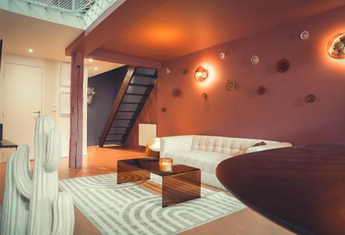 a living room with a couch and a table at Bisous Bisous - Romantique Room in Riom