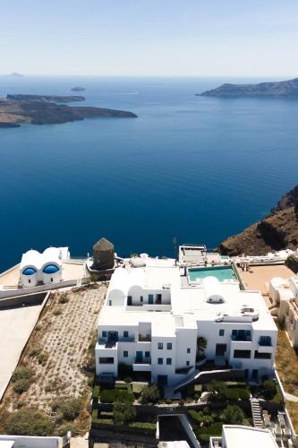 a white house with a view of the water at Aeifos Boutique Hotel in Imerovigli