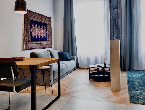a living room with a couch and a table at Lujza B studio 44 in Budapest