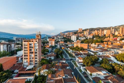 an aerial view of a city with buildings at Travelers Orange Suites in Medellín