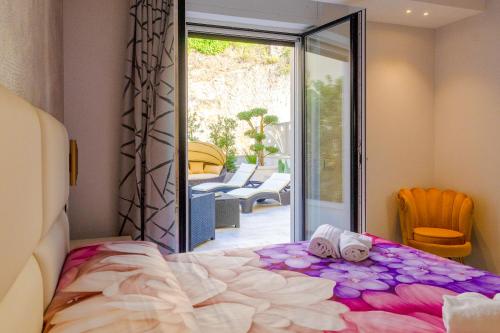 a bedroom with a bed and a sliding glass door at Residence AleDen in Vieste