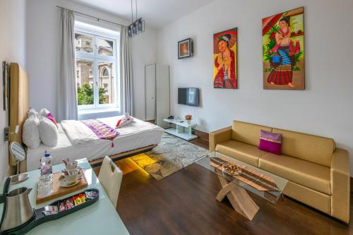 a living room with a couch and a table at Andrassy Thai Hotel in Budapest