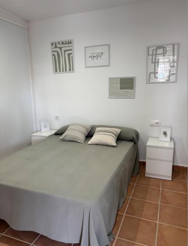 a bedroom with a large bed with two night stands at Villa con piscina in Chiclana de la Frontera