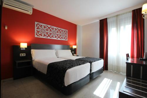 Ένα ή περισσότερα κρεβάτια σε δωμάτιο στο Hotel Venecia