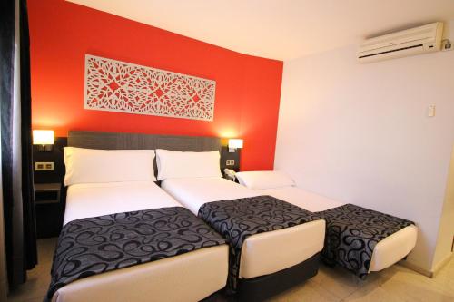 Ένα ή περισσότερα κρεβάτια σε δωμάτιο στο Hotel Venecia