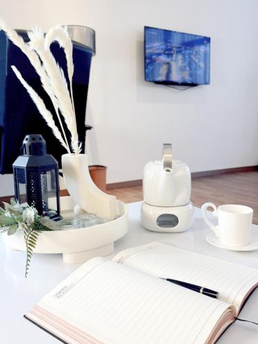 a table with an open notebook and a book at The Latrobe - Bangsar Trade Centre in Kuala Lumpur