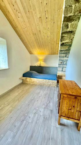 a bedroom with a bed and a table in a room at La Jasse in Saint-Beauzély