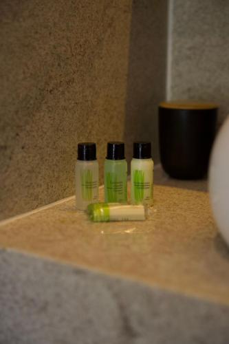 two bottles of toothpaste and a toothbrush on a counter at Casa Nengueta - Lapinha da Serra in Santana do Riacho