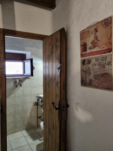 a bathroom with a door open to a bathroom with a toilet at Alojamiento Rural El Pontón in Pontones