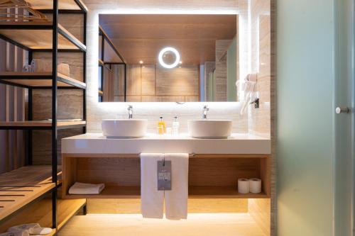 a bathroom with two sinks and a mirror at AP Cabanas Beach & Nature - Adults Friendly in Cabanas de Tavira