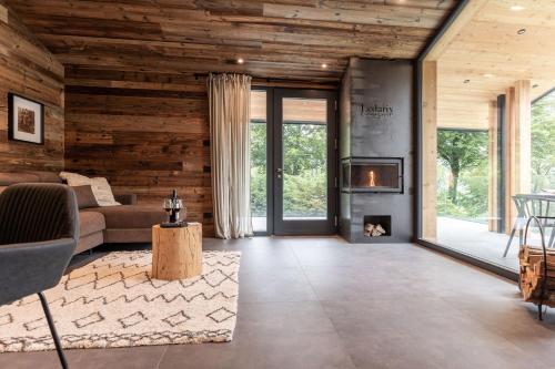 a living room with a couch and a fireplace at Ledarix Charm Chalet in Ledro