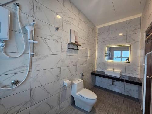 a white bathroom with a toilet and a sink at jia Residence 21 pax Karaoke & Snooker in Ipoh