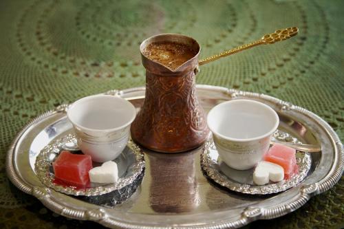 a silver tray with two cups and a vase at Hedgehog's Home - Ježeva kućica Free Parking in Sarajevo