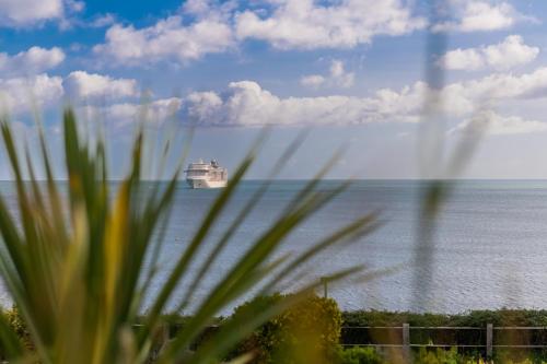 a cruise ship in the ocean with the ocean at The Royal Duchy Hotel in Falmouth