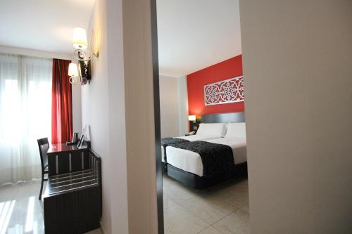 Ένα ή περισσότερα κρεβάτια σε δωμάτιο στο Hotel Venecia
