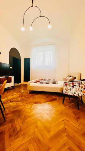 a bedroom with a bed in the middle of a room at S11 Apartman in Debrecen