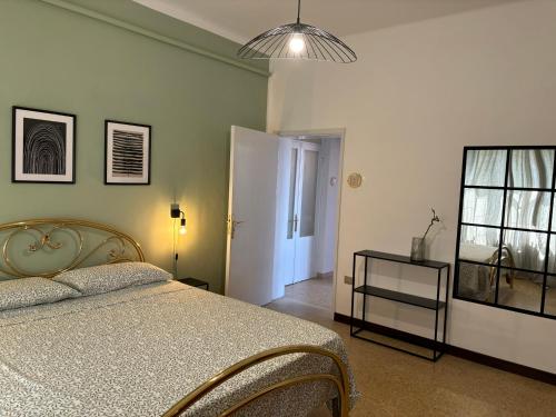 a bedroom with a bed and a window and a lamp at Eleganza retrò con vista sulla Basilica in Loreto