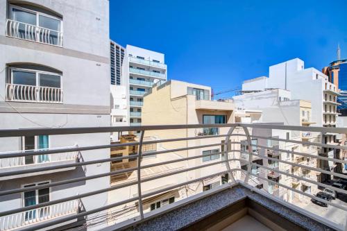 un balcón de un edificio con edificios blancos en Modern 2BR Apt with Balconies in St Julians, Paceville - APT 5 by Vaganza, en San Julián