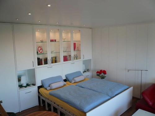 a bedroom with a bed in a room with cabinets at Apartment Korthals 42 in Wangerland