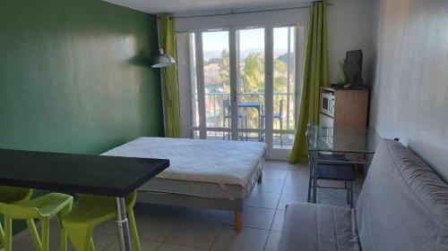 Cette chambre comprend un lit, une table et un canapé. dans l'établissement FREJUS Studio avec place de parking, à Fréjus