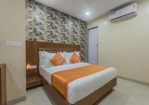 a bedroom with a bed with a rock wall at Hotel Arton Regency - Near Mumbai International Airport in Mumbai