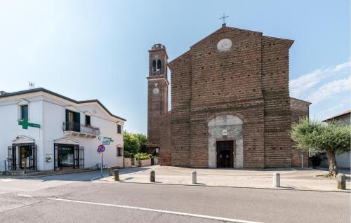 a brick building with a clock tower on a street at Casa Lucia in Villadose